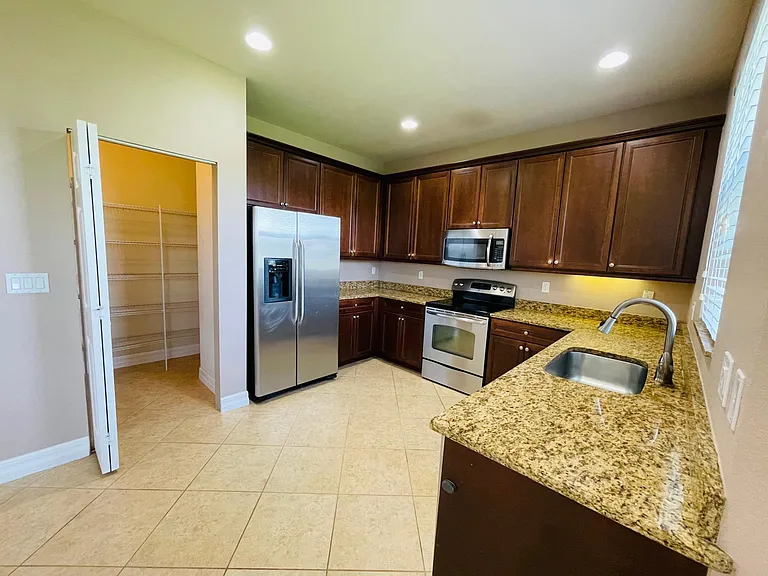 Spacious kitchen with stainless steel and walk in pantry