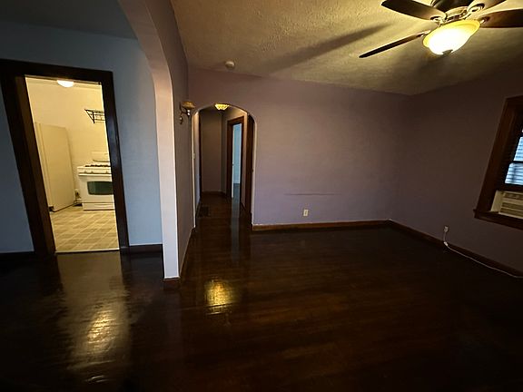 Open living room and dining room with lots of windows and natural light.
