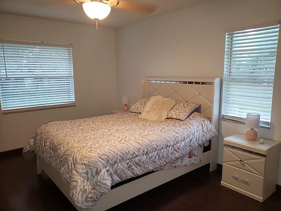 Master Bedroom with laminate floors. Shown furnished but house will be unfurnished.