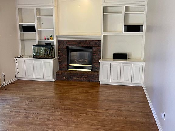 Family room with built in, gas fireplace and large windows