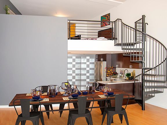 Alternative angle to the dining/ open kitchen area with a spiral staircase to the loft bedroom.
