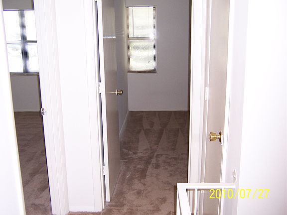 top of stairs showing both bedrooms and linen closet
