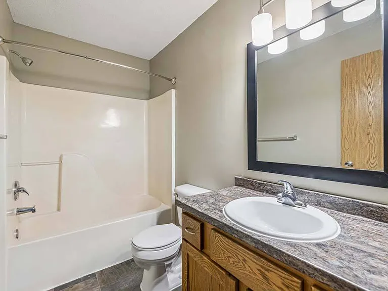 A clean, well-appointed bathroom with modern lighting and timeless finishes offers a fresh, comfortable space to start and end your day.