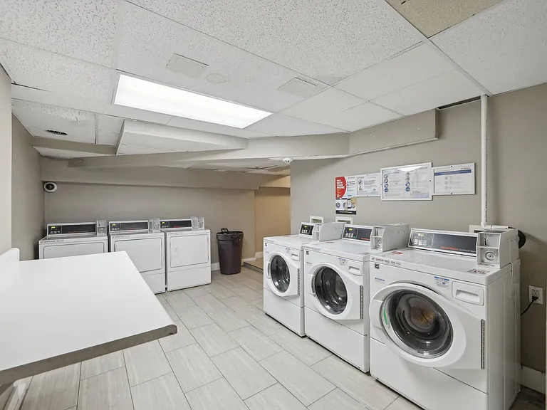 Apartment with a common area laundry with multiple washers and dryers