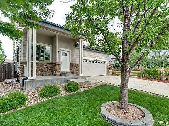 Covered front porch with new front door and beautiful landscaped.
