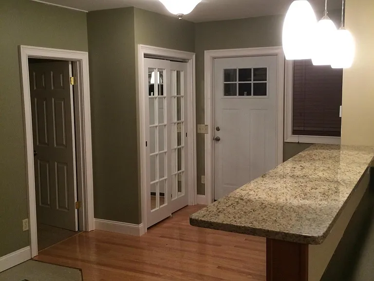 Kitchen granite bartop looking toward front door, front closet and 1st flr bedroom