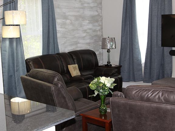 Leather....shiplap accent wall as you enter. 52 in tv. room also has a lush single memory foam ottoman pullout