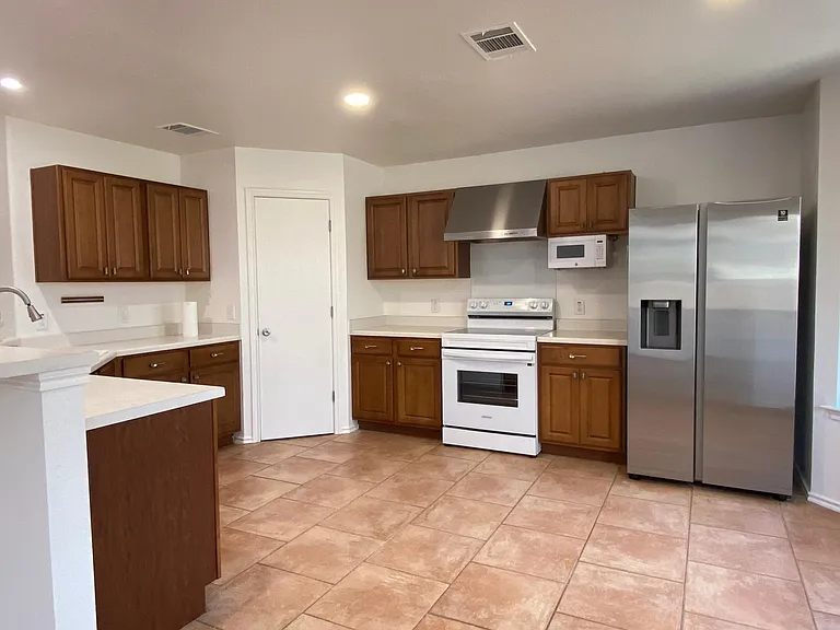 Kitchen + New Samsung Refrigerator.
Additional Microwave on counter