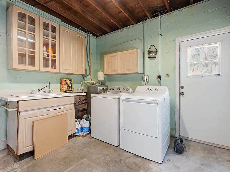 Large capacity washer and dryer located in garage along with 1/2 bathroom and all the beach necessities you could need.