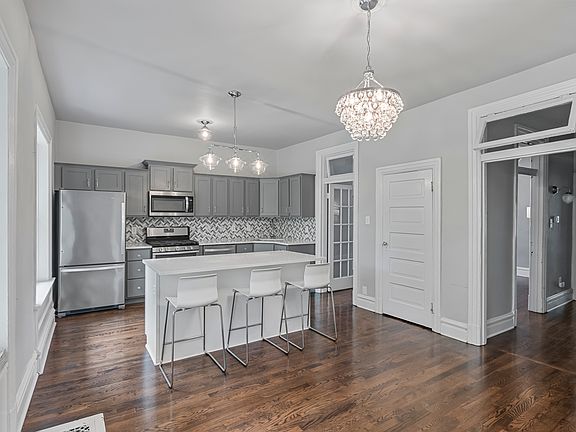 Kitchen accesses living room and hallway to bathroom