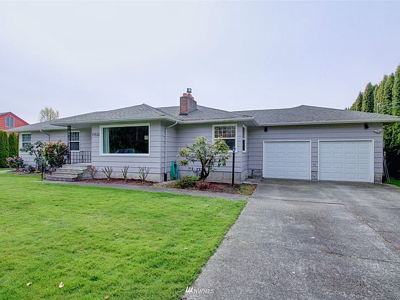 Front view showing 2 car garage. Home has that classic mid century curb appeal and was built with quality wood. Siding is cedar and will last a lifetime. 