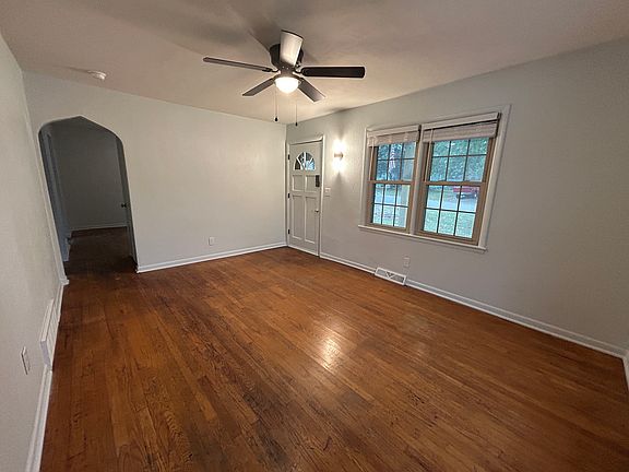 Living room, view to see front door and arched hallway to the rest of the house.