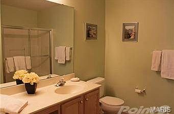 Solid surface vanity top with area for vanity stool.