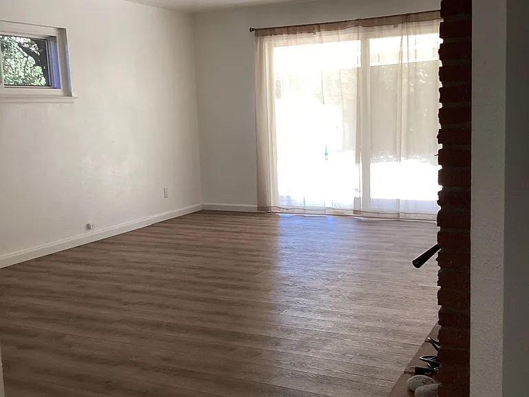 Living room with sliding door out to large patio.