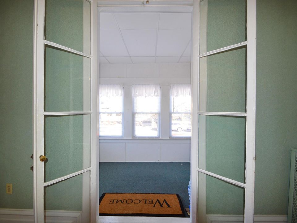 Looking from the living room to the front porch - the living room has been painted to a soft beige