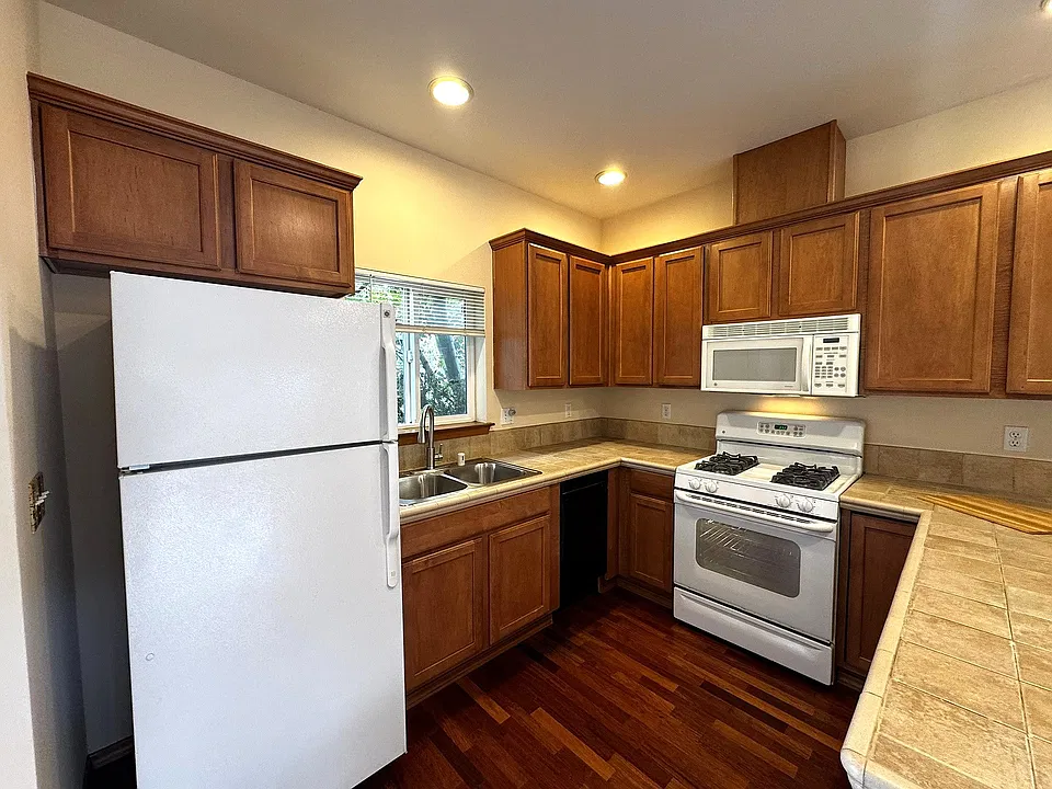 Beautiful kitchen beside entrance with gas stove, new double sink, new faucet, built-in microwave & dishwasher.