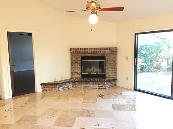 Travertine tile flooring in great room, decorative fireplace