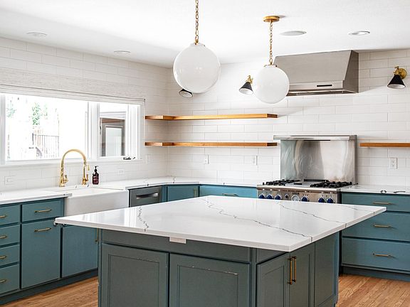 Newly designed Kitchen. Kitchen island with room for many chairs / stools.
