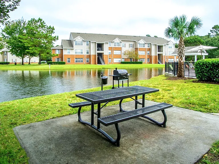 Relax and unwind at the serene picnic area at Eagles Pointe Apartments. Overlooking a peaceful lake, this spot features convenient grills and seating, perfect for enjoying outdoor meals and gatherings.