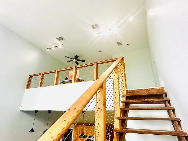 Vaulted ceilings and floating staircase to loft , master bed, walk in shower walk in closet and bathroom area