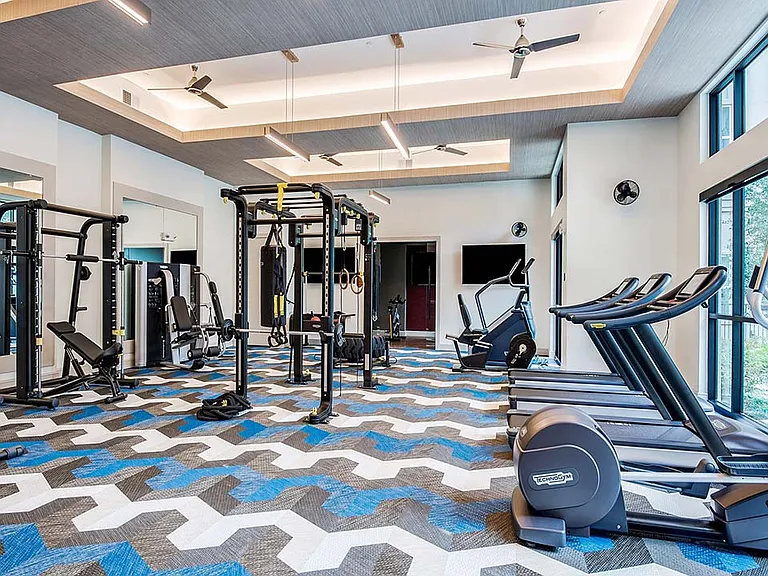 Griffis Frisco fitness center with cardio machines and weight equipment.