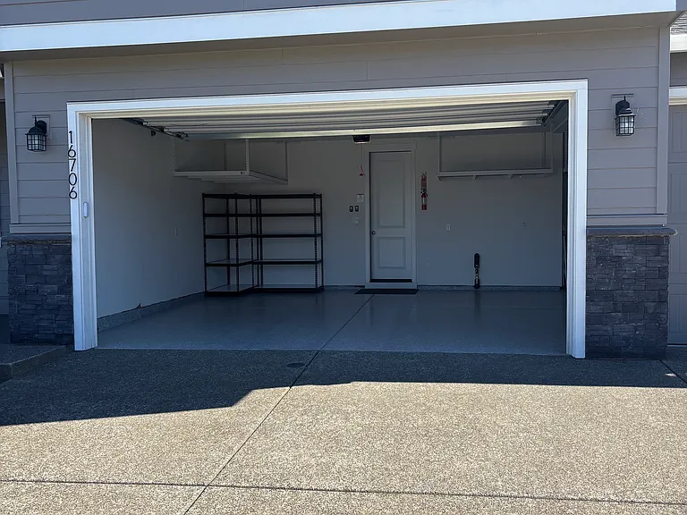 GARAGE WITH FLOOR COATING & PLENTY OF OVERHEAD STORAGE & SHELF STORAGE