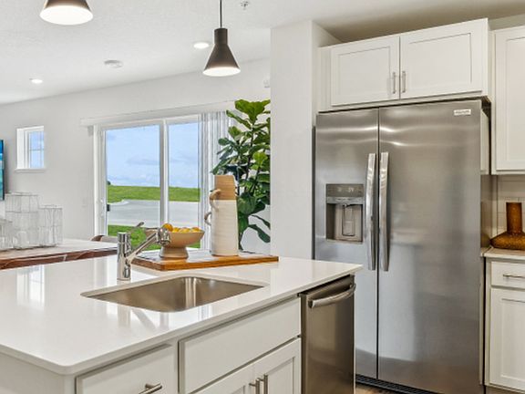 For streamlined cleaning, the undermount stainless steel sink with a designer faucet is within easy reach of the multi-cycle dishwasher