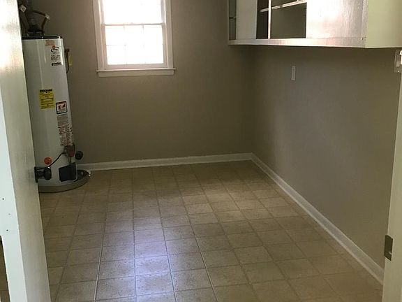 very large laundry room with brand new washer and dryer