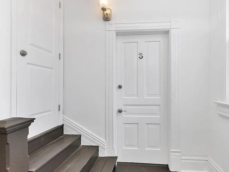 upstairs foyer access with storage area for bikes or coat rack