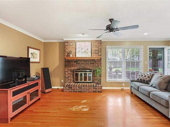 The family room has gleaming hardwood floors, fireplace and awesome views of the backyard.