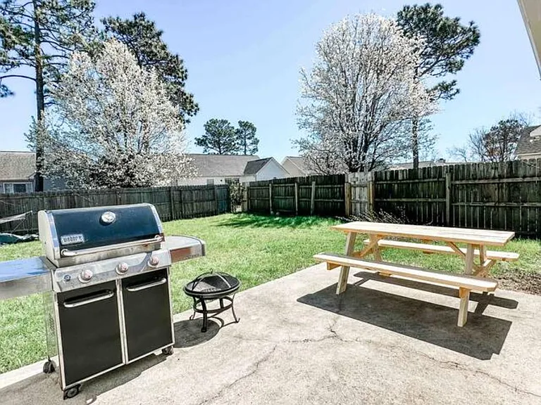 Concrete pad in backyard for furniture and grill. Picnic bench is available to the tenant for use.