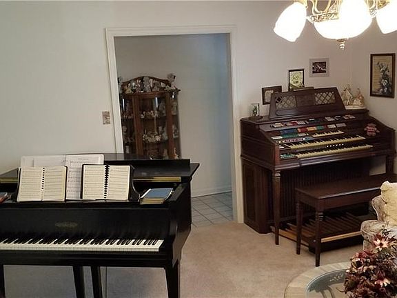 Nice living room but is crowded with both the baby grand and the organ...