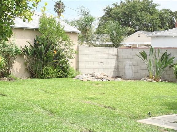 Backyard Also Has 2-Car Garage With Attached Workshop