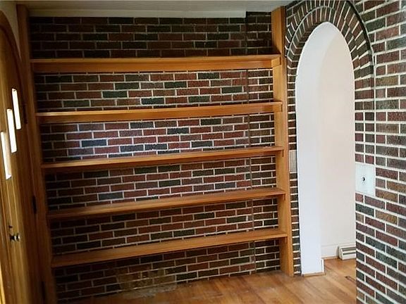 Entering from the curved doorway to a sitting area or library with skylight