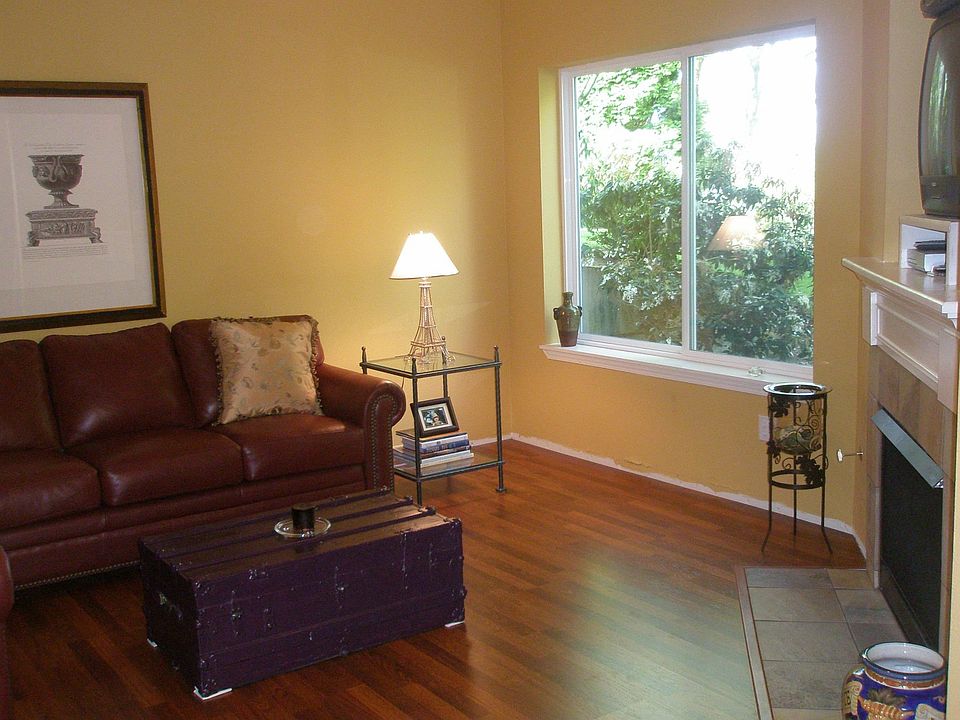 New Brazilian Cherry laminate flooring in living room, bedroom & dining