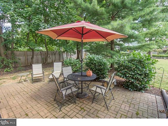 Charming private patio surrounded by lush greenery_perfect for morning coffee, outdoor dining, or simply enjoying the peaceful surroundings.