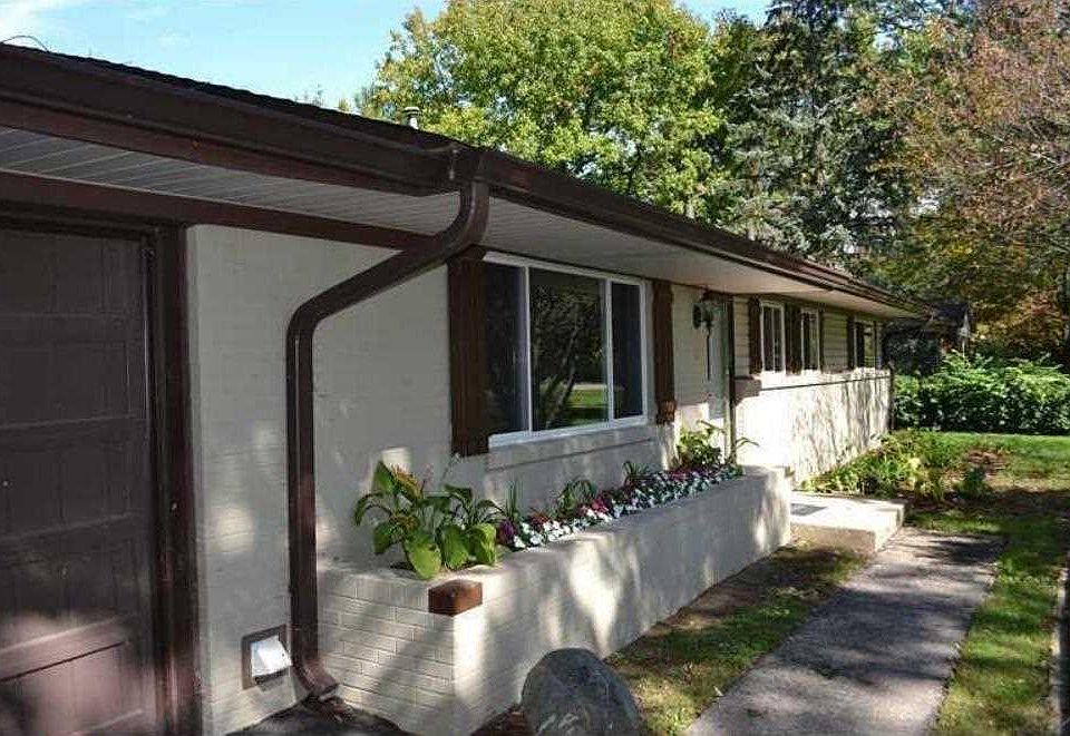 Front walk with built in brick flower bed.