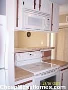 All new cream colored matching appliances / travertine counter tops
