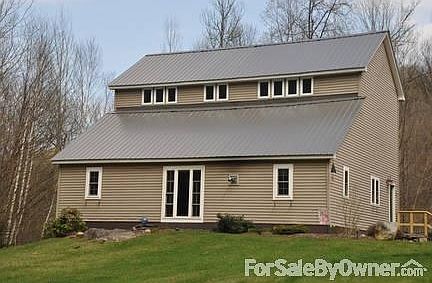 House
						:
						View of the house from the front yard.
Perennial Gardens around front and side.