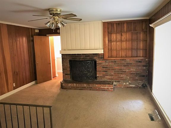 Another view of the cozy den with the gas fireplace