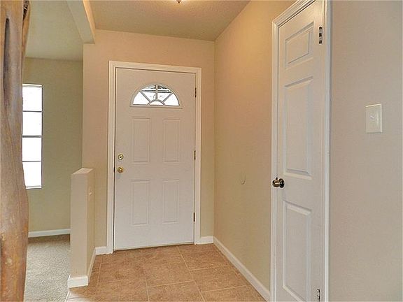 Entryway with new door, tile, light fixtures and paint!