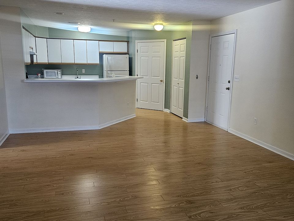 Camera angled with view of the kitchen, laundry room, closet and front door