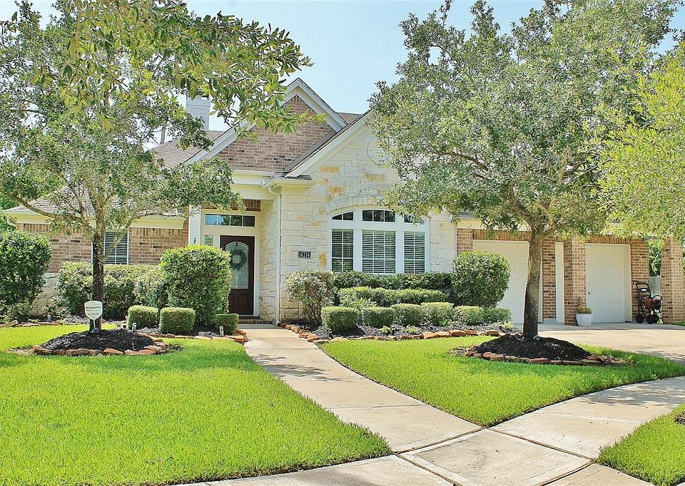 Beautiful curb appeal at this 4 bedroom home tucked away at the end of a cul-de-sac. River rocks surround all of the mature landscaping and keeping your yard green is a breeze with the sprinkler system.
