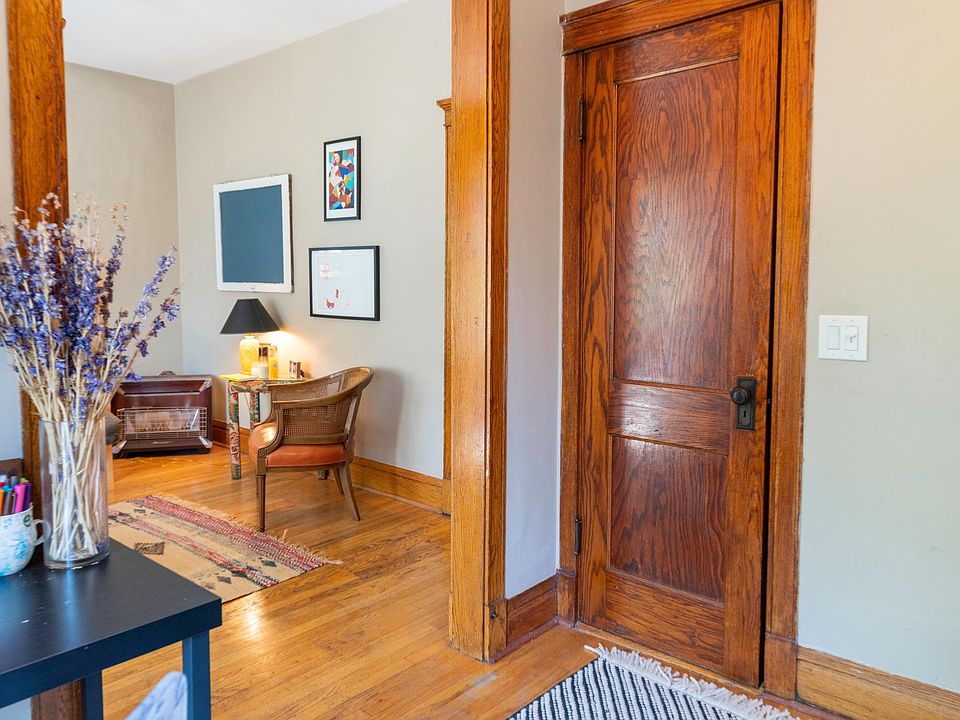 Den with closet with view of living room.