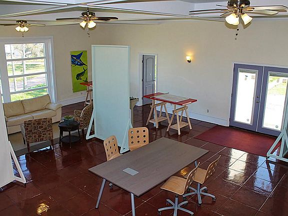 Ballroom style space on 2nd level with large windows & beautiful stained concrete floors