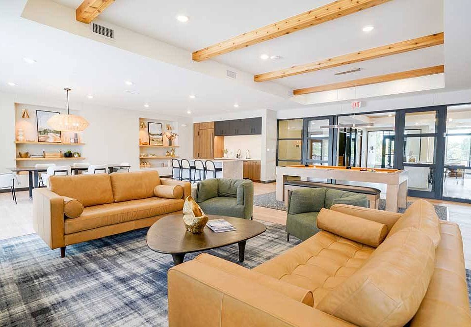 Immerse yourself in the upscale ambiance of our clubroom, where entertainment meets refinement with a pool table, modern kitchen, and chic seating areas.