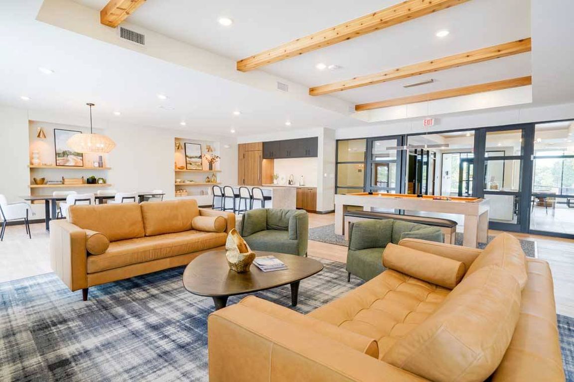 Immerse yourself in the upscale ambiance of our clubroom, where entertainment meets refinement with a pool table, modern kitchen, and chic seating areas.