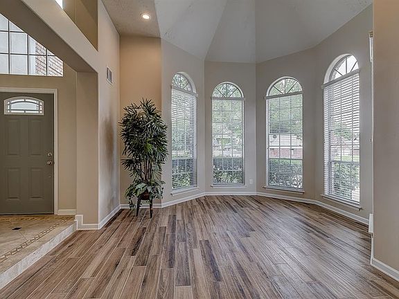 The flooring in this space is a porcelain tile that has a nice dimension of neutral colors in a wood-like pattern that will blend nicely with all styles of furniture.