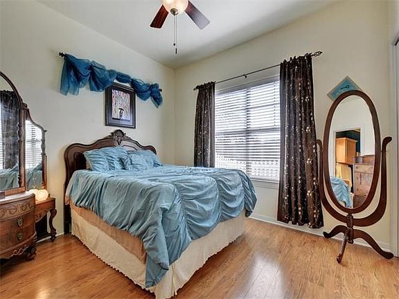 Lovely master with high ceilings and fan.