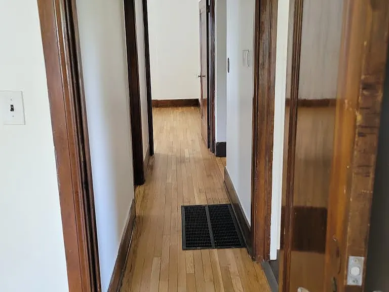 Hallway leading to bathroom and bedrooms.